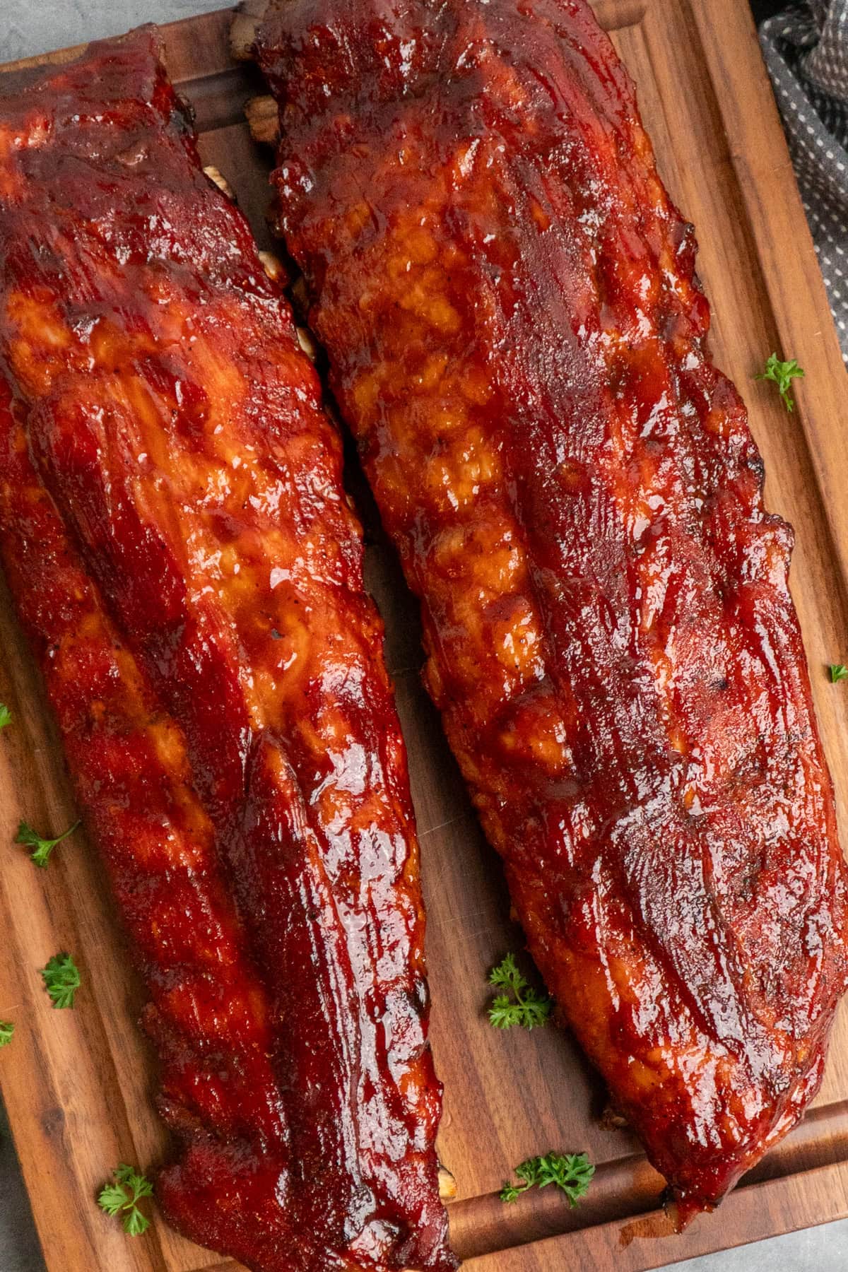 Two rack of baby back ribs that have just been pulled off the smoker.