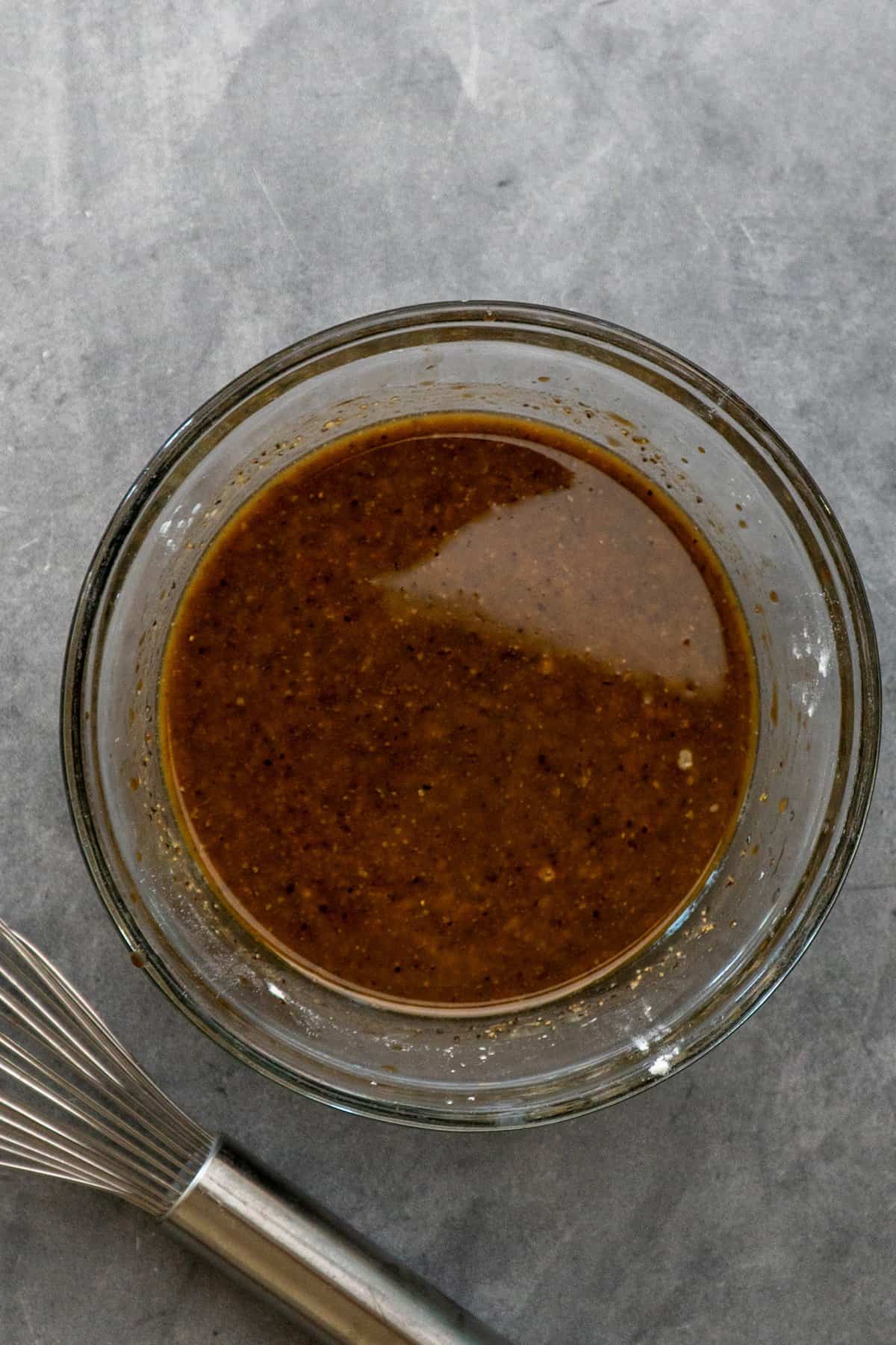 Sauce ingredients mixed together in a clear bowl.