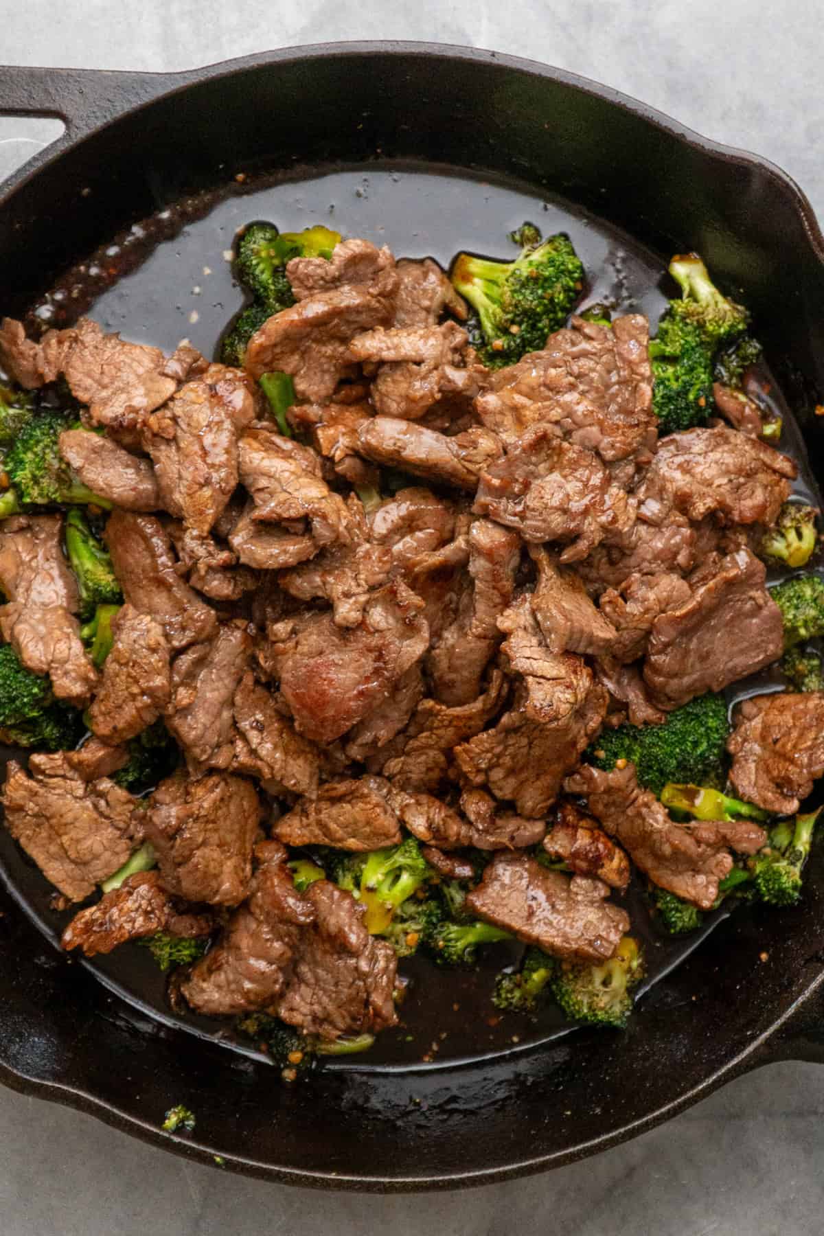 Cooked flank steak combined with broccoli and sauce.