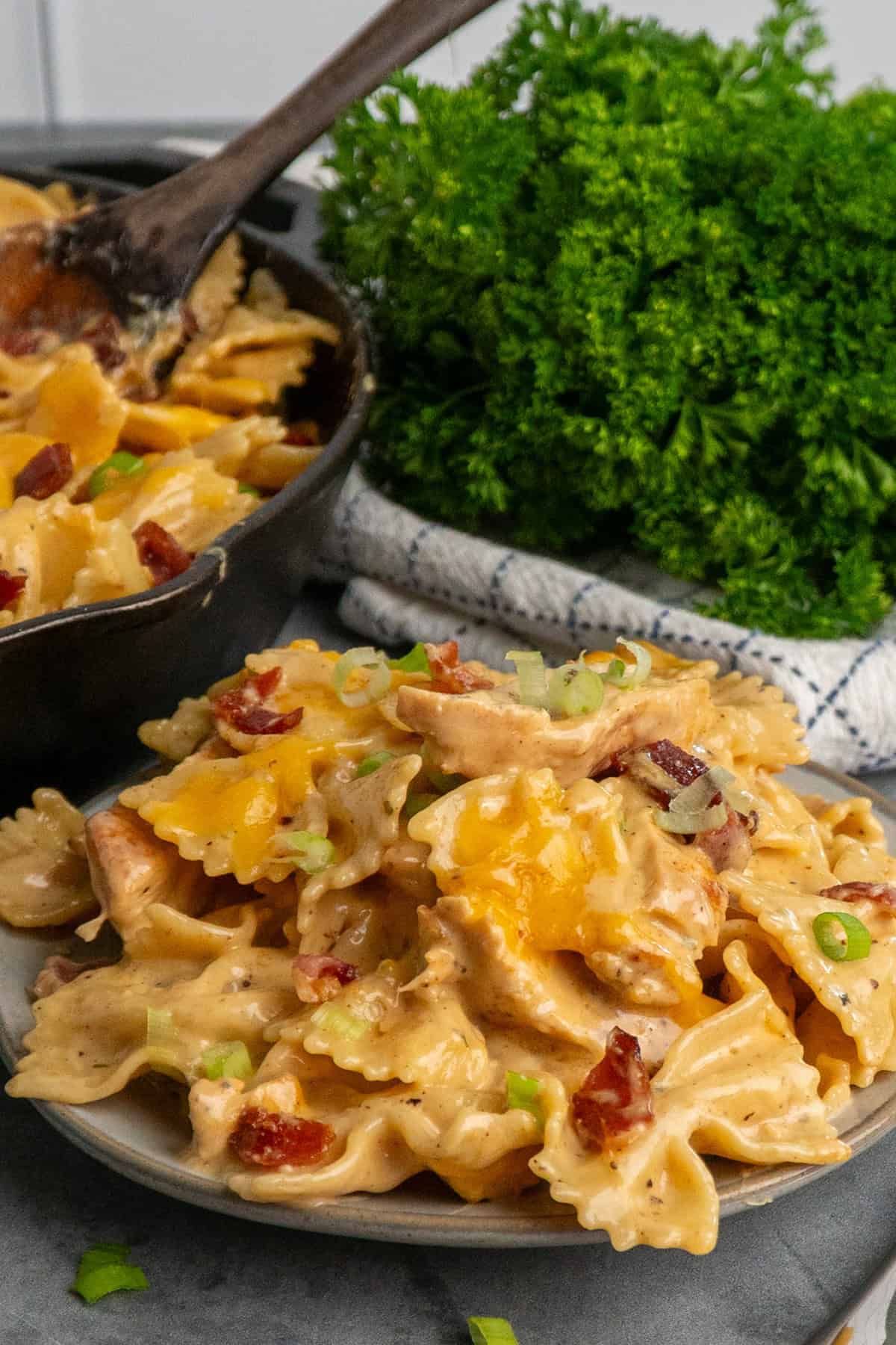 Crack chicken pasta on a plate and in a skillet.