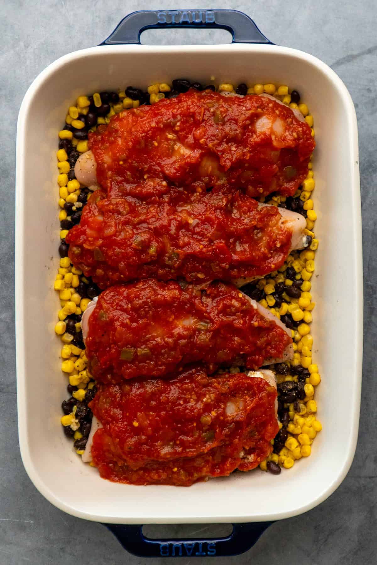 Salsa and garlic poured over the top of the chicken breasts.