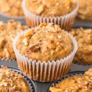 Banana nut muffins on a muffin pan.