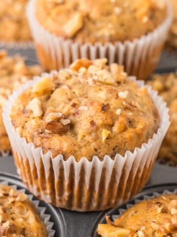 Banana nut muffins on a muffin pan.