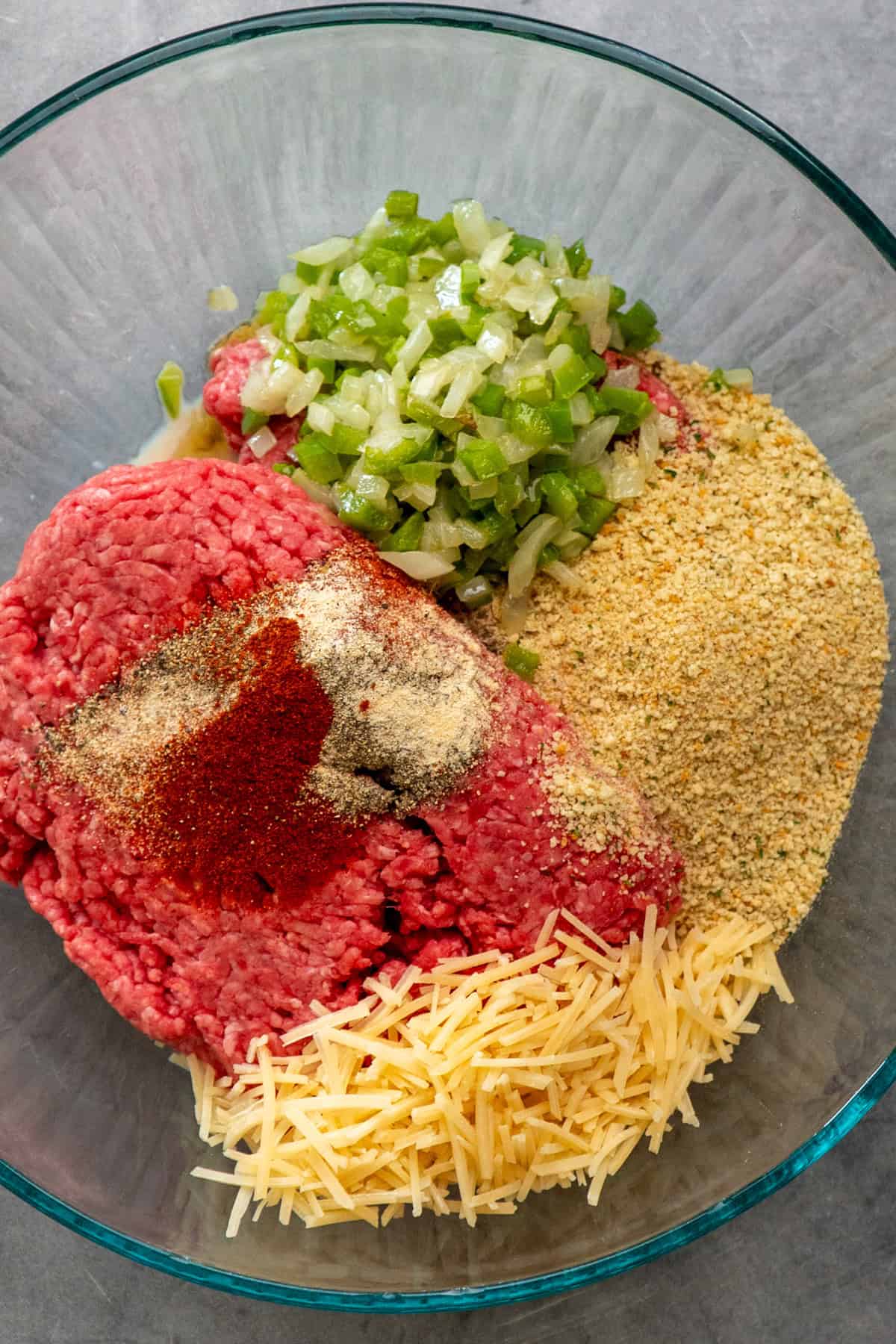 All the Salisbury steak patty ingredients in a clear bowl ready to be mixed together.