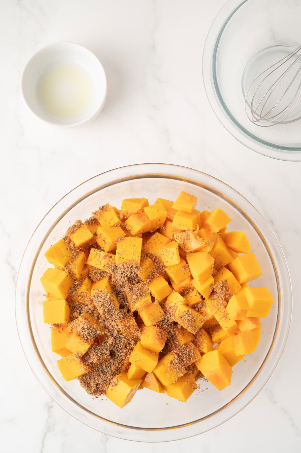 Cubed butternut squash with olive oil and seasoning mix combined. 