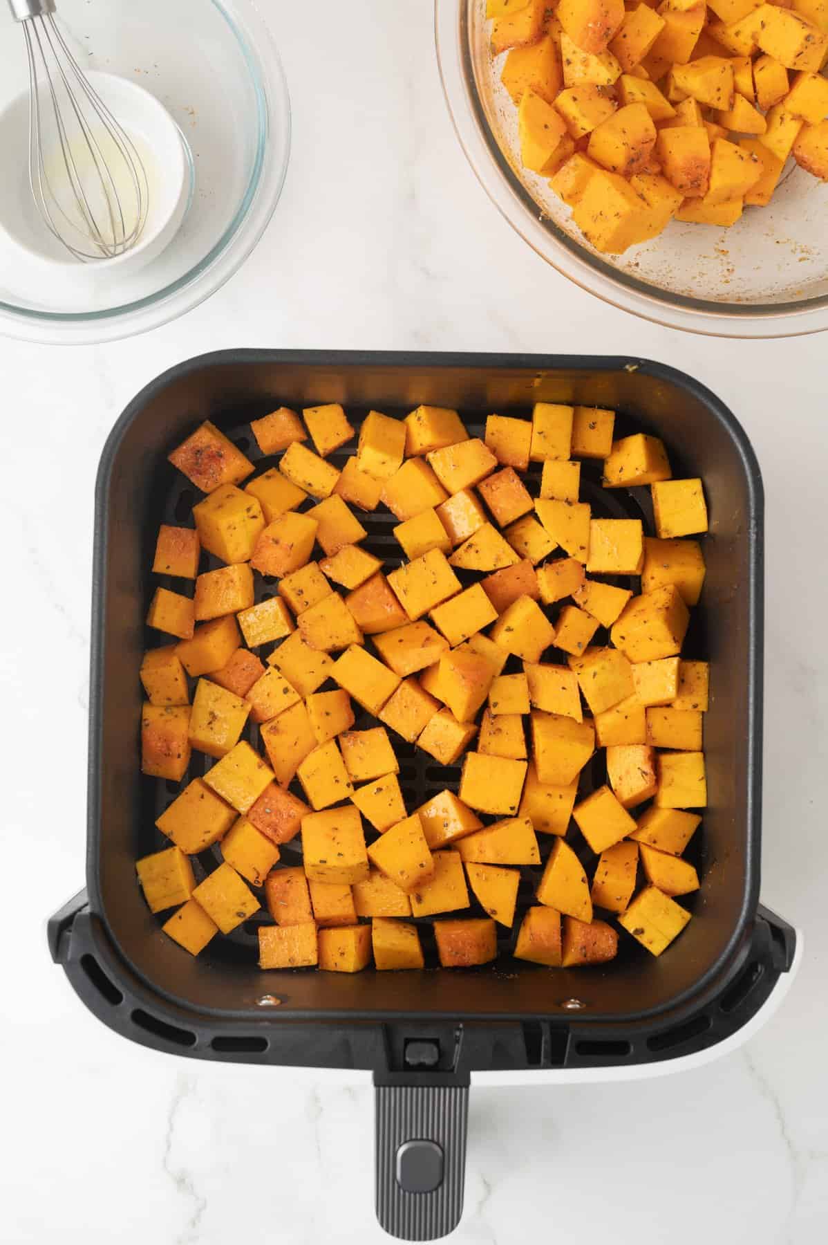 A single layer of squash in the air fryer.