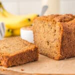 Peanut butter banana bread sliced open on a cutting board.