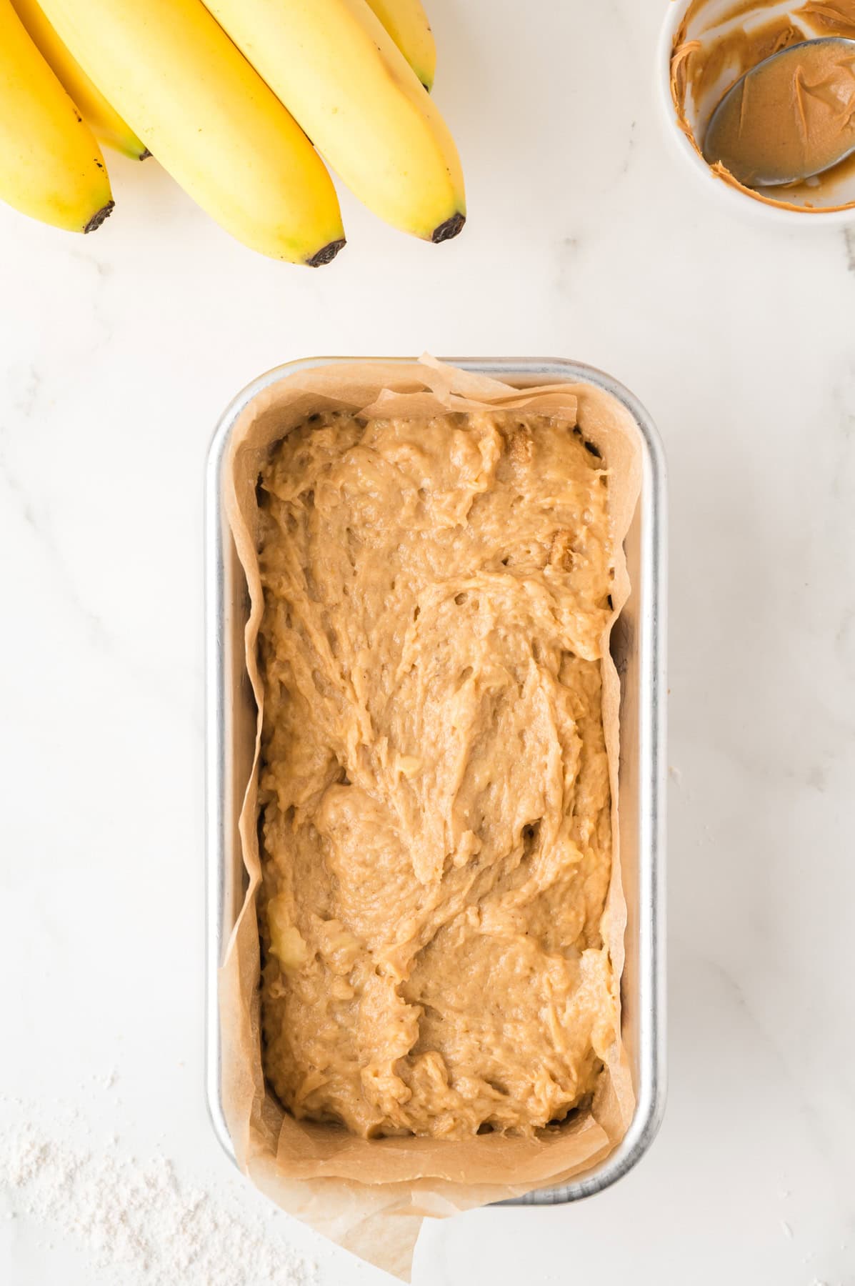 The pb banana bread batter transferred into the prepared loaf pan.