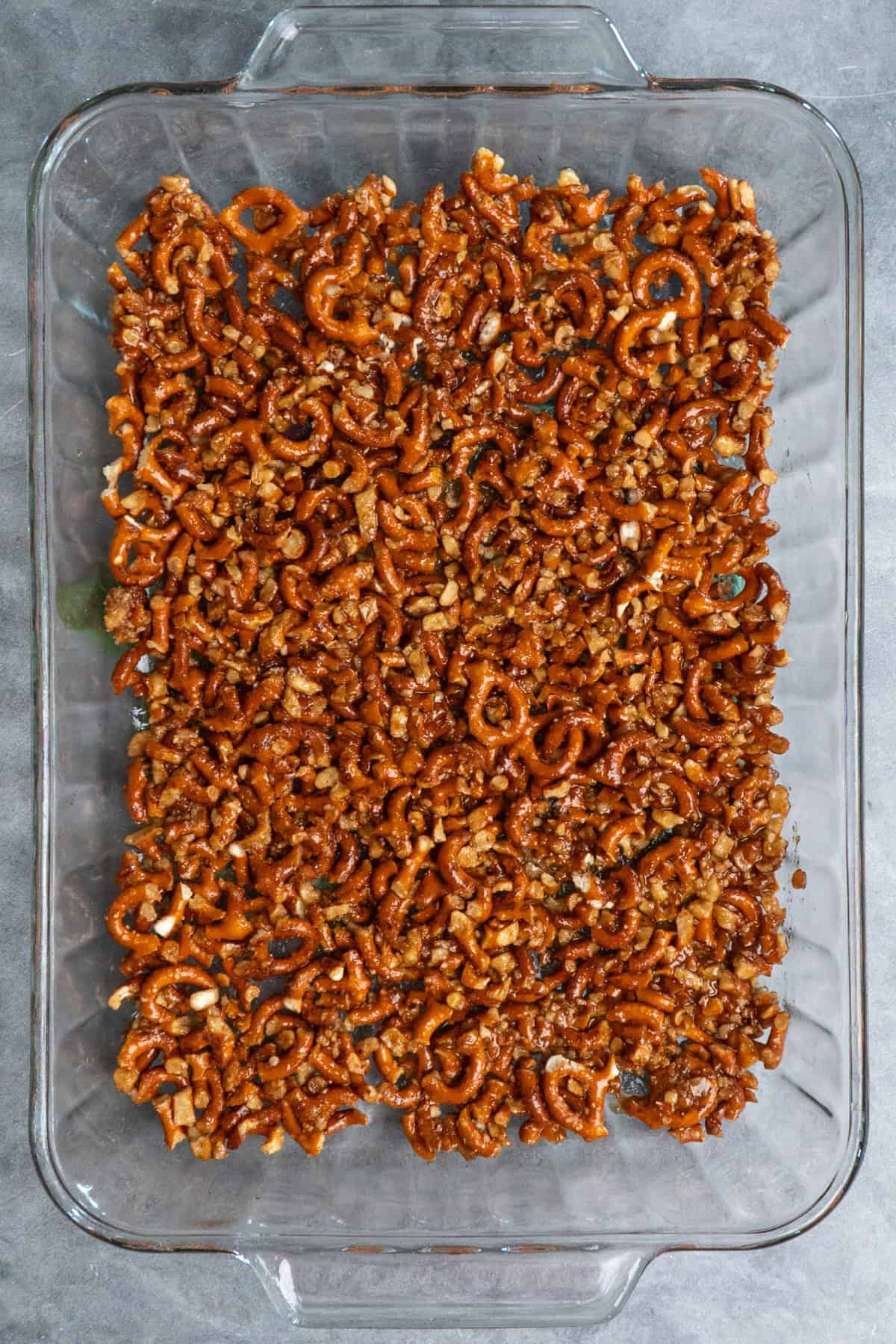 Pretzel crust in a clear baking dish.