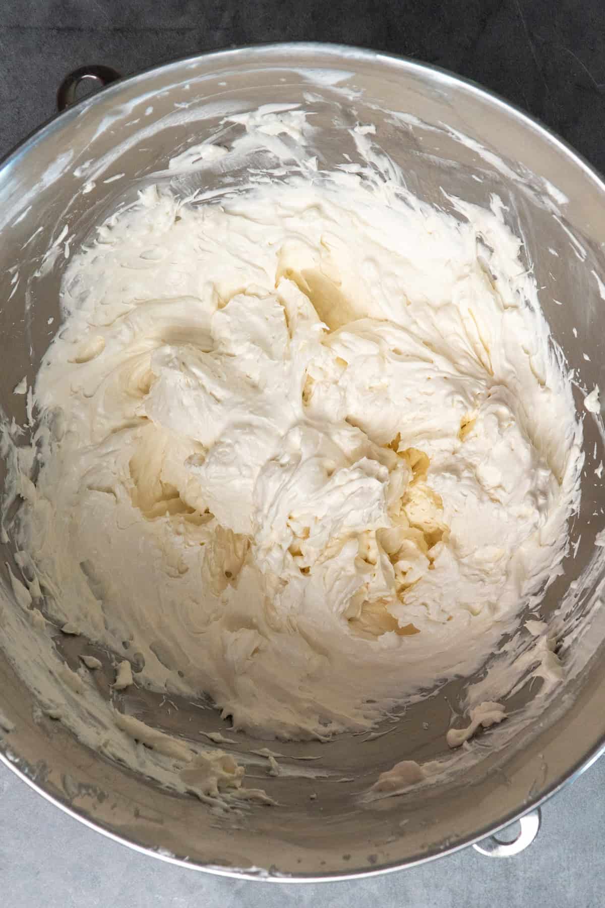 Cream cheese, cool whip, sugar and vanilla whip together in a mixing bowl.