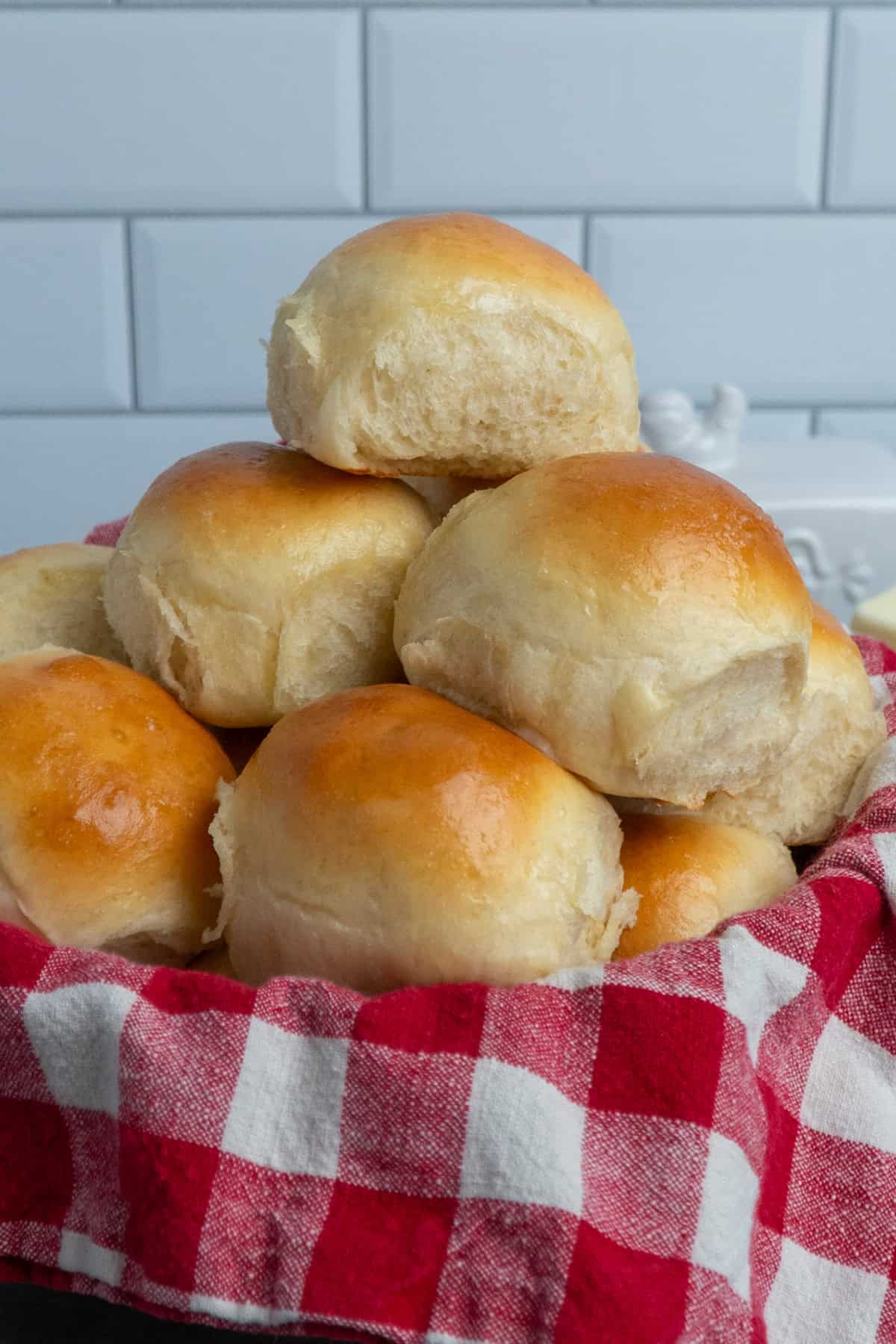 Brioche rolls stacked in a basket.