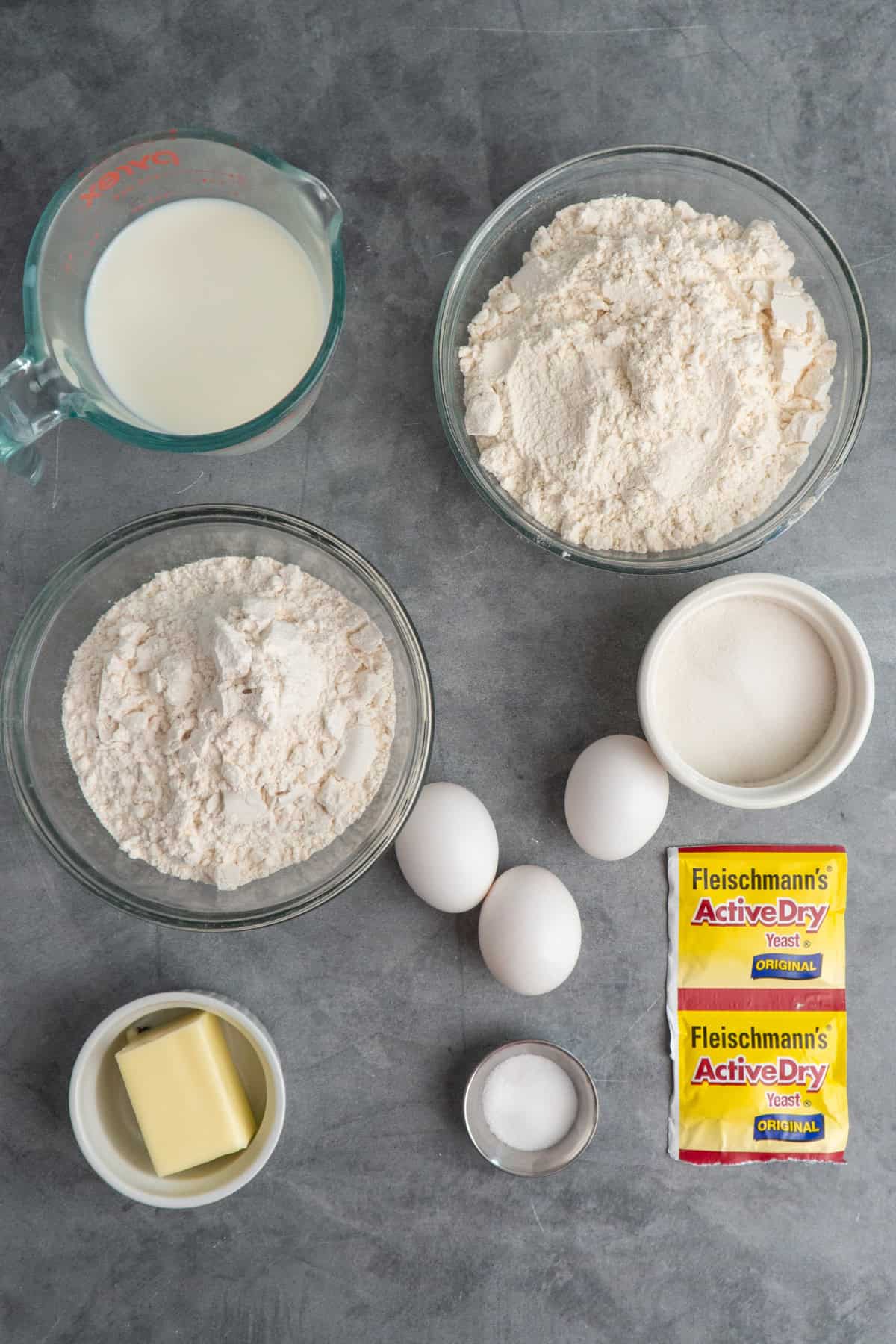 Ingredients to make brioche dinner rolls on a table.