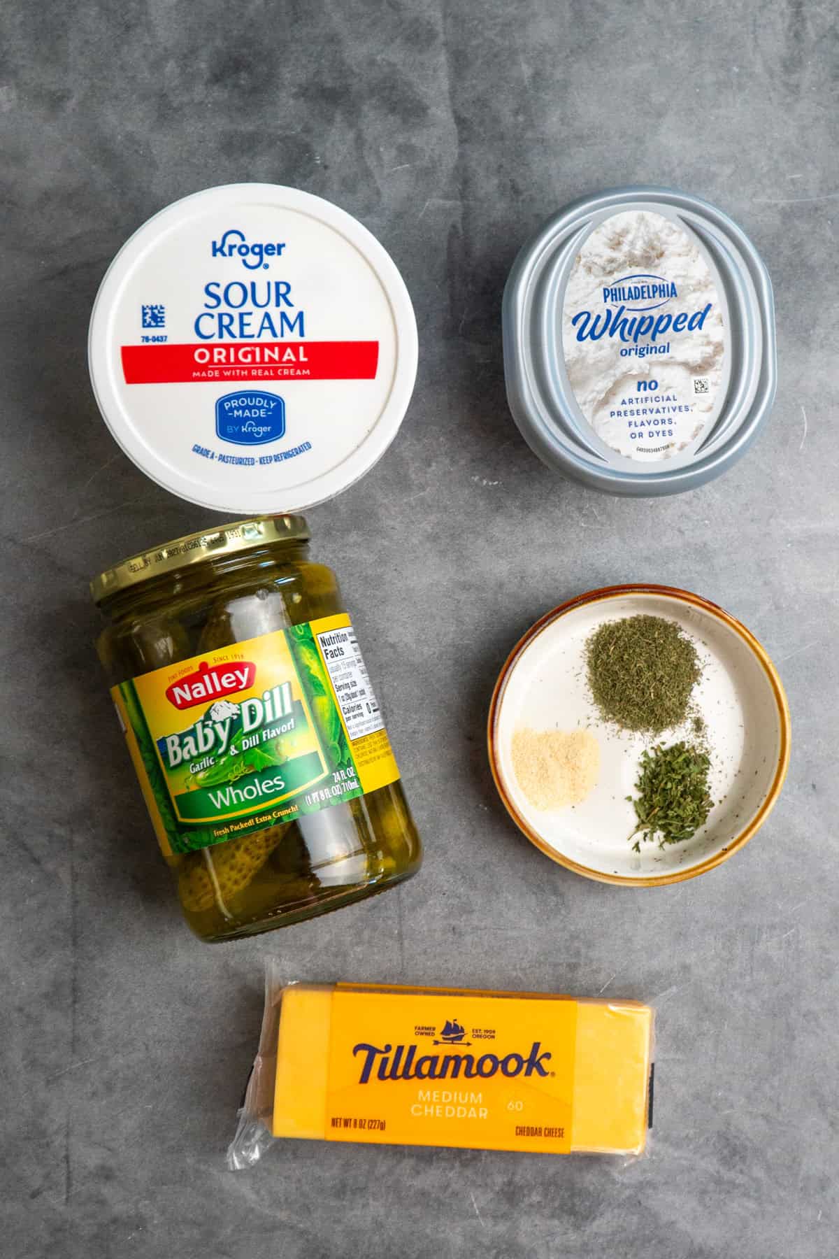 Ingredients to make dill pickle dip on a table.