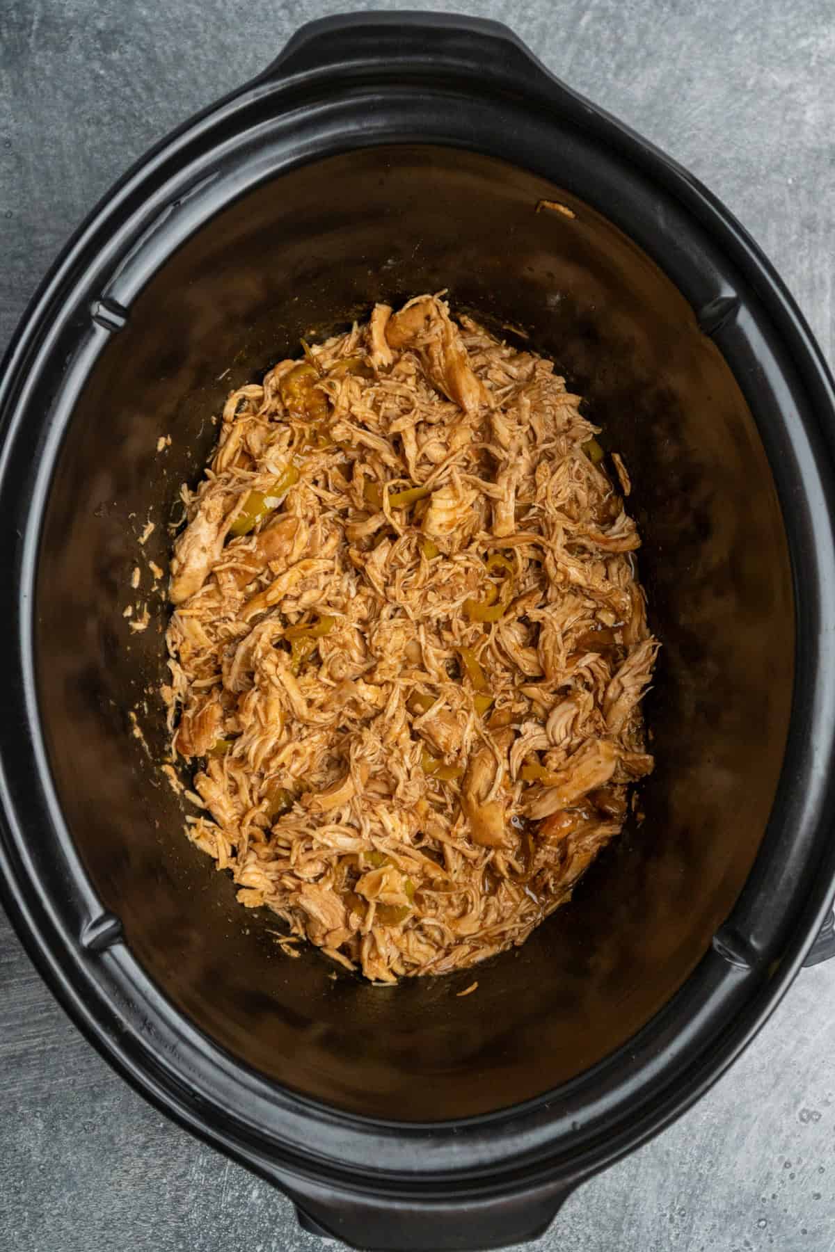 Chicken that has been shredded and mixed into the gravy.