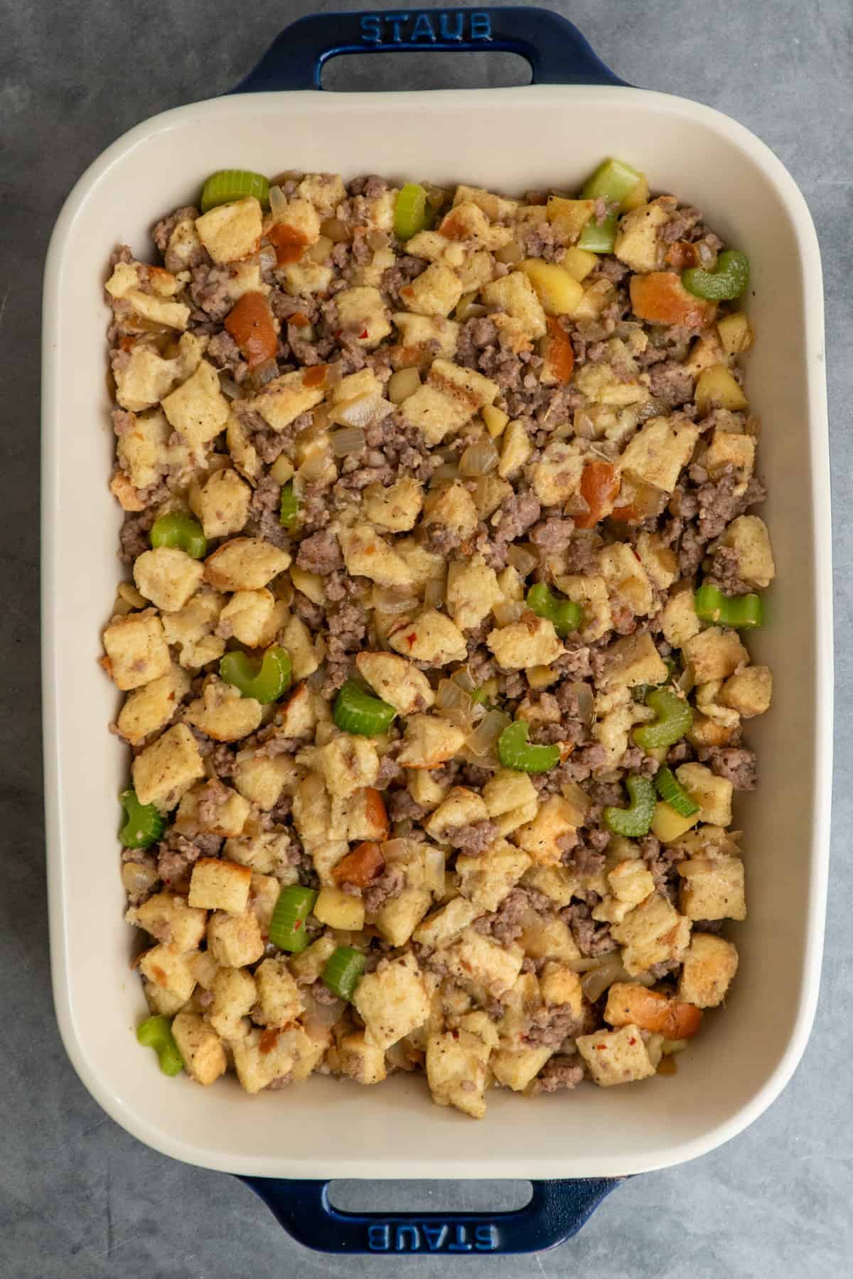 Sausage stuffing in a baking dish ready to be cooked.