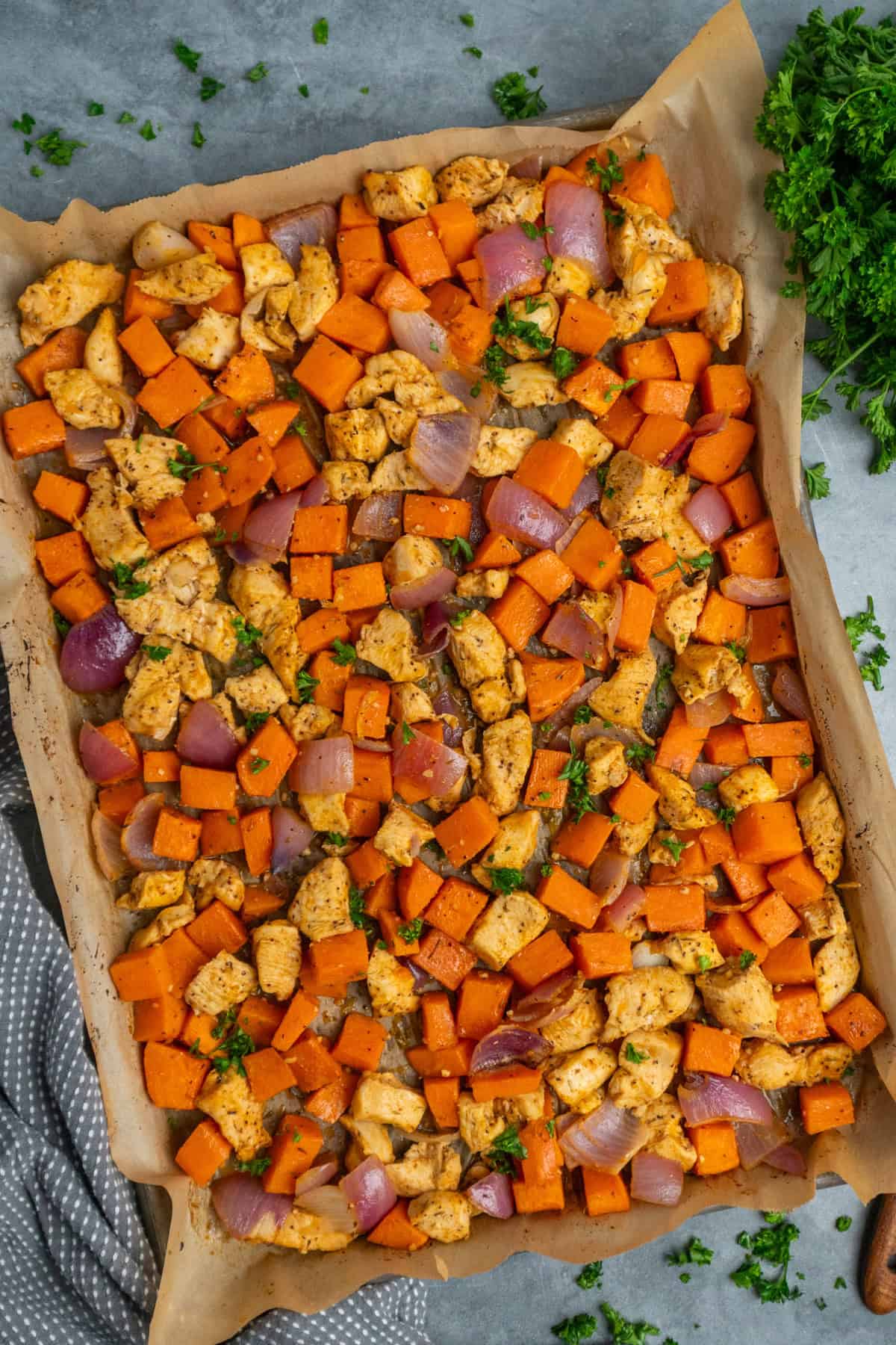 Chicken and sweet potatoes that have been roasted in the oven.