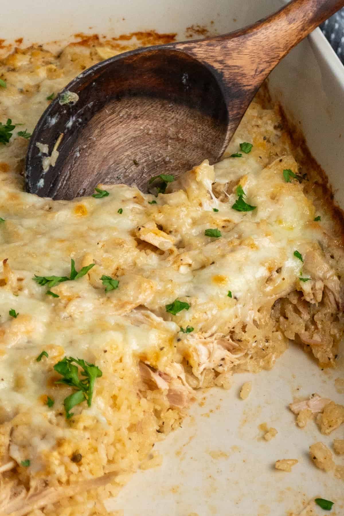 Chicken and rice casserole with a portion taken out of it.