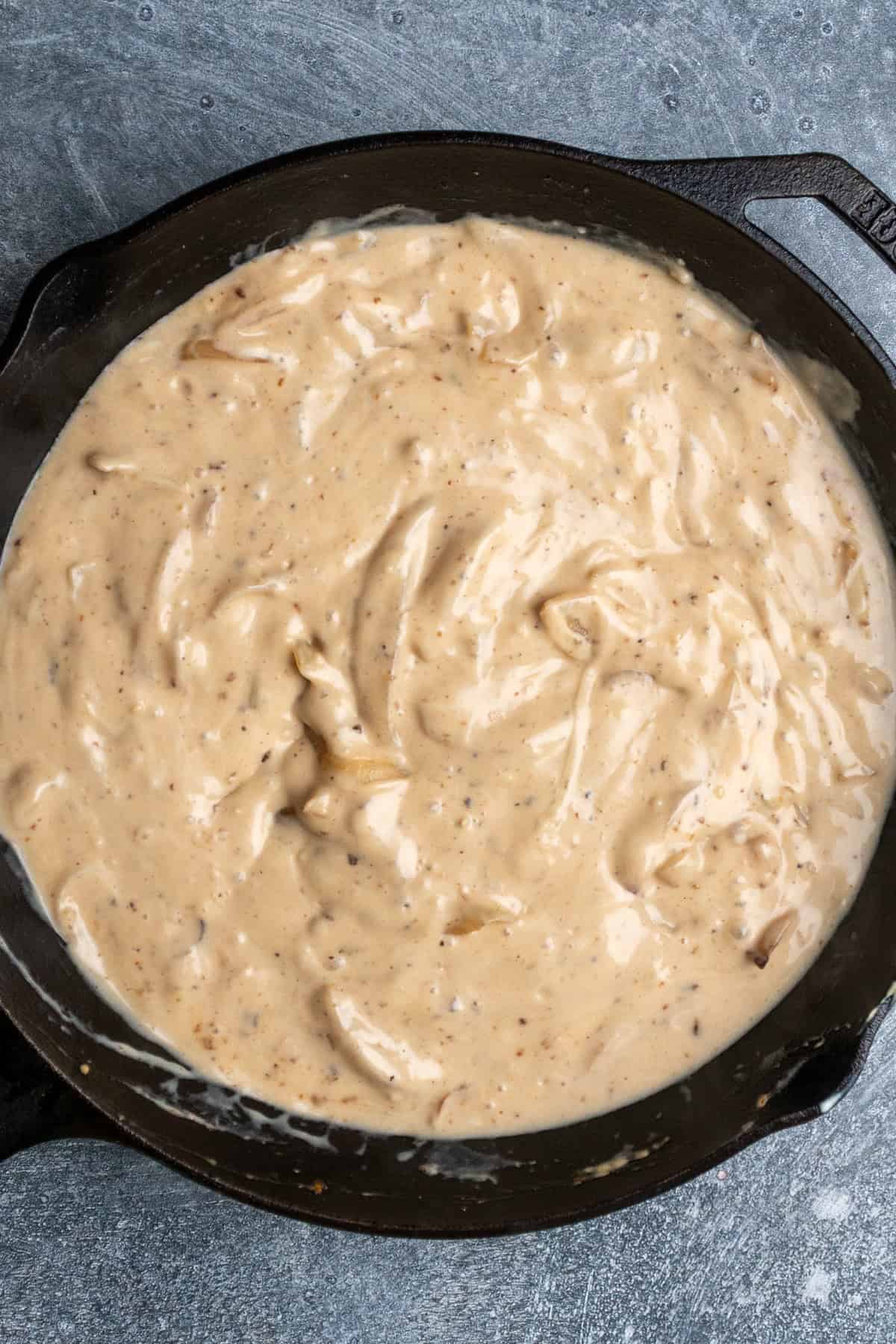 Sauteed onion combined with sauce ingredients.