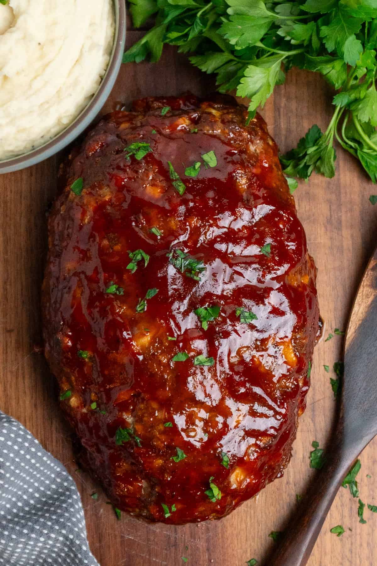 Finished Stove Top stuffing meatloaf on a wood cutting board.