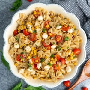 Caprese pasta salad in a white bowl ready to be served.