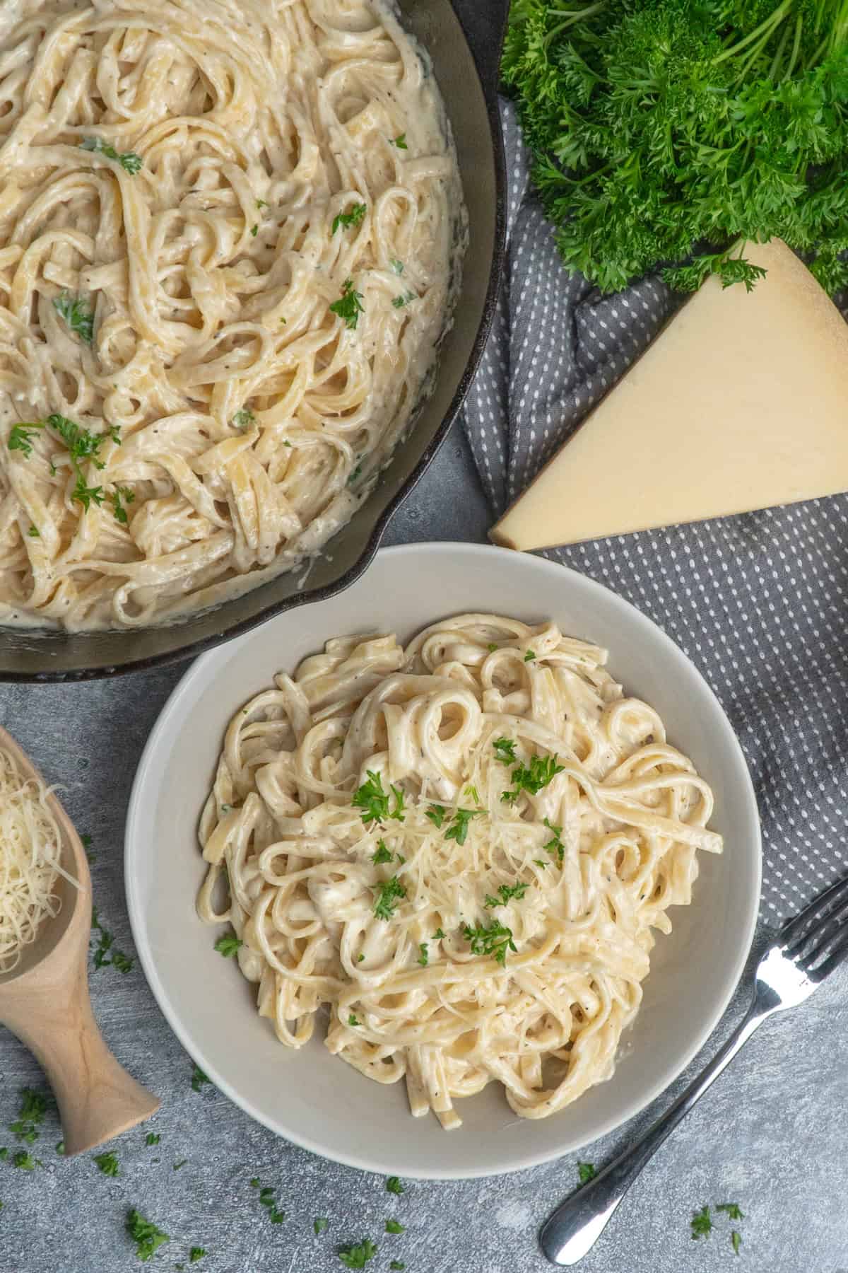 A bowl of pasta with alfredo sauce. 
