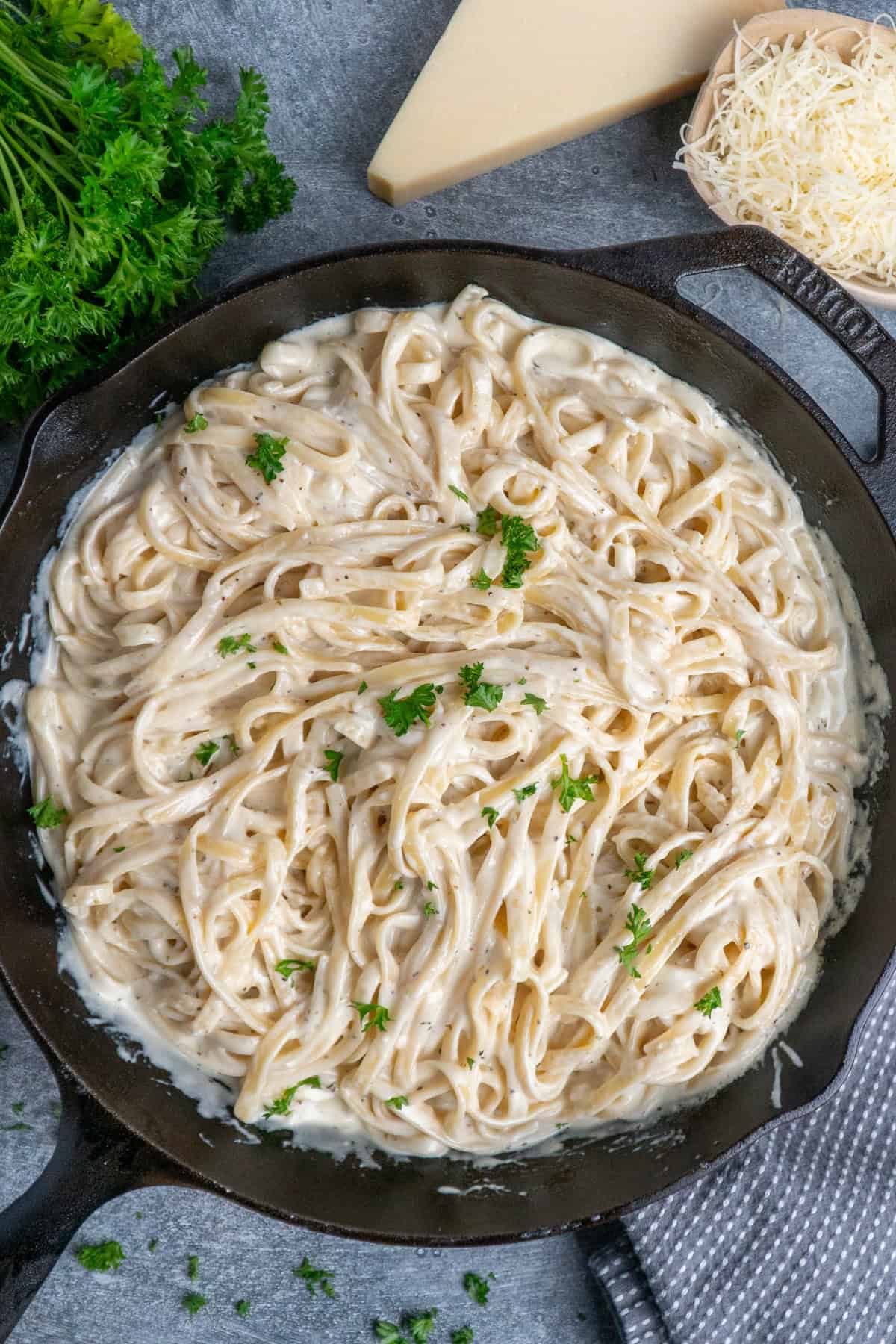 Pasta with alfredo sauce in a skillet.