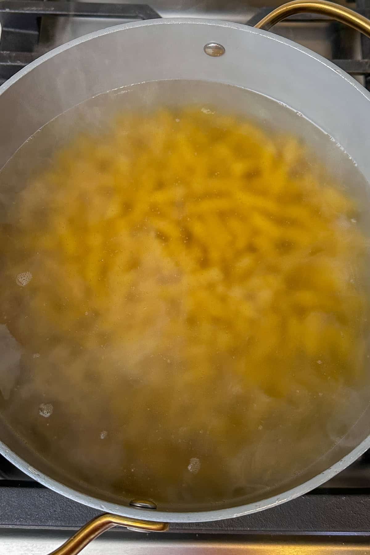 Rotini pasta being cooked in a large pot.