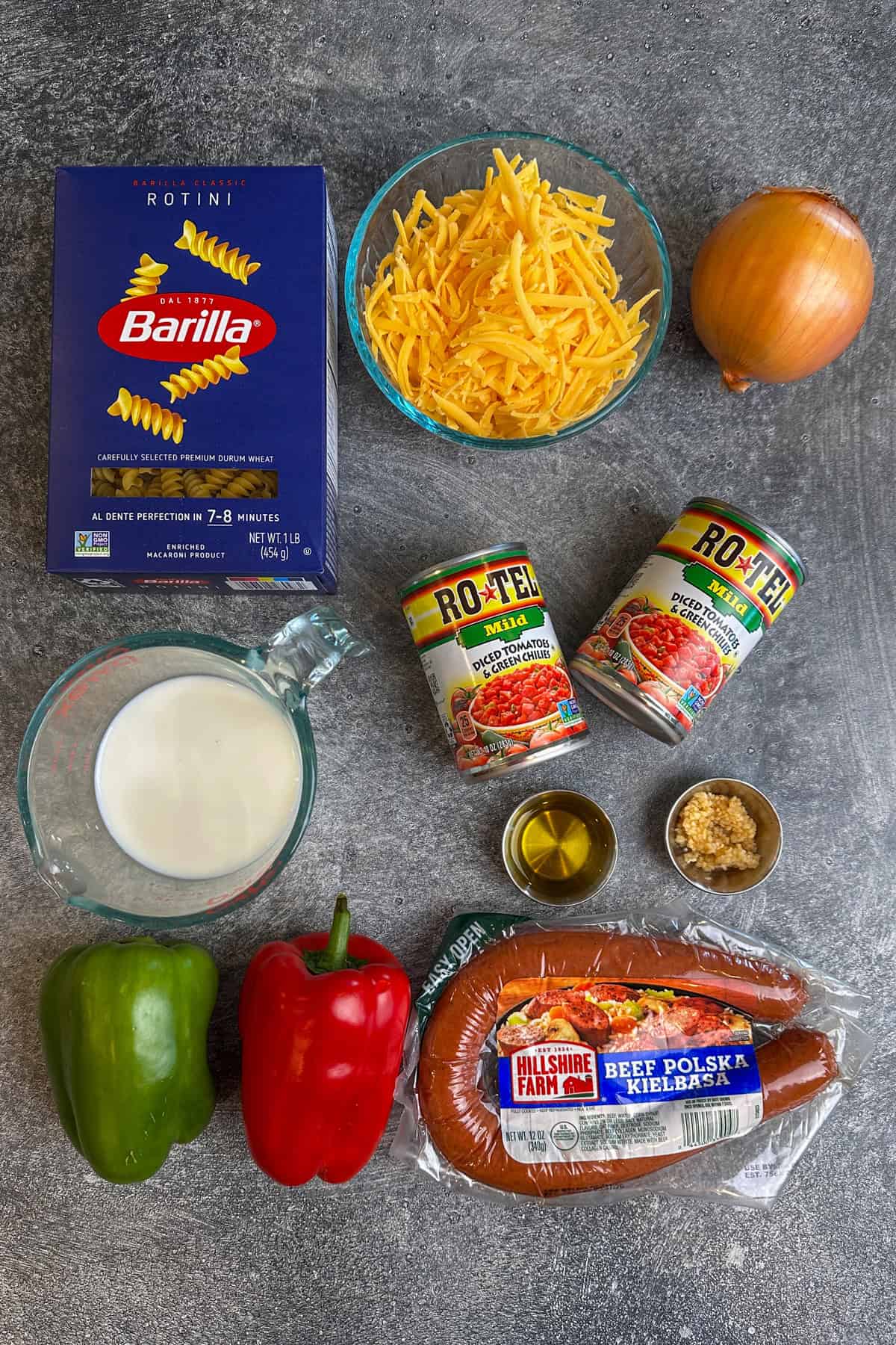 Ingredients to make Rotel pasta on a gray countertop.
