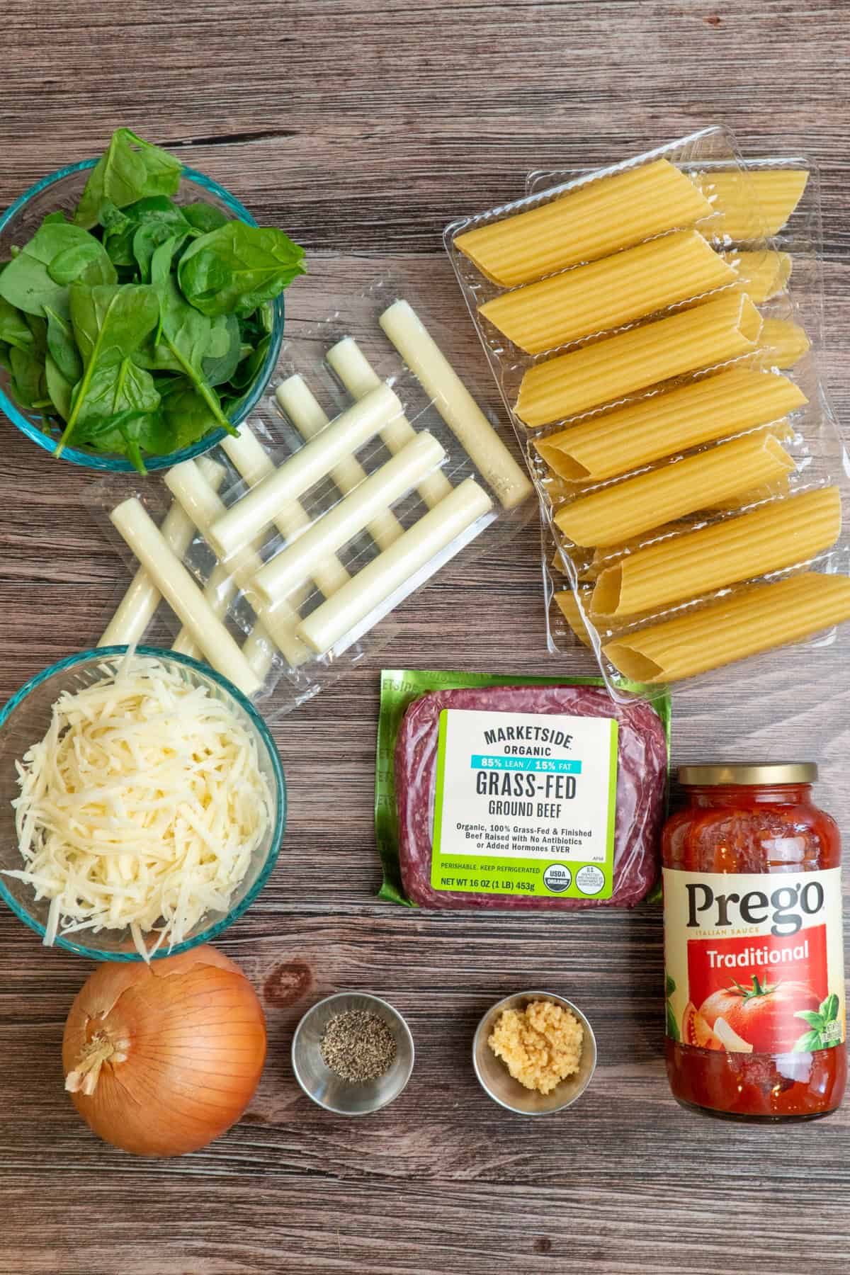 Ingredients to make string cheese manicotti on a wood countertop.