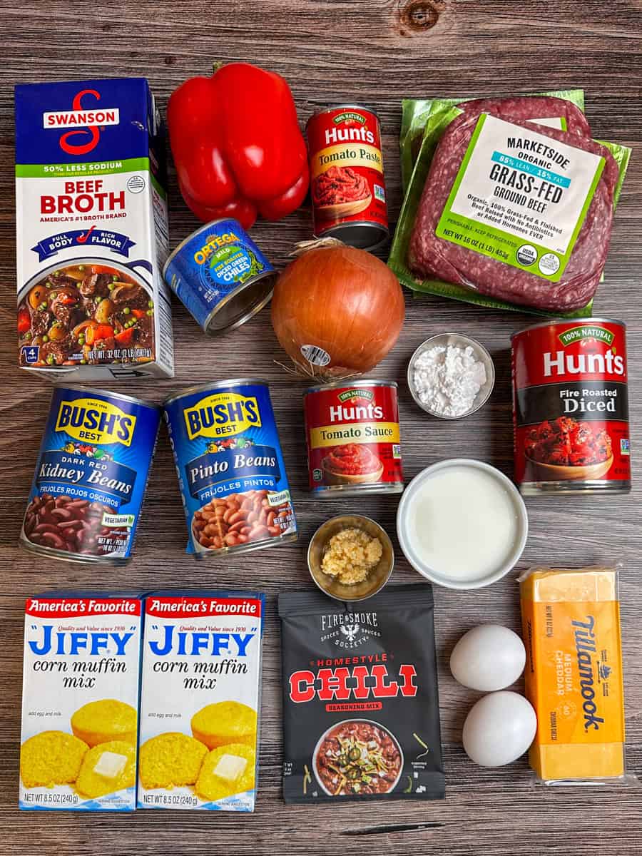 Ingredients to make chili cornbread casserole on a wood countertop.
