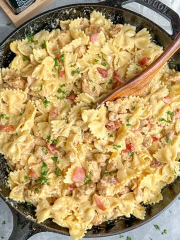 Chicken bacon ranch pasta in a skillet with a wooden spoon.