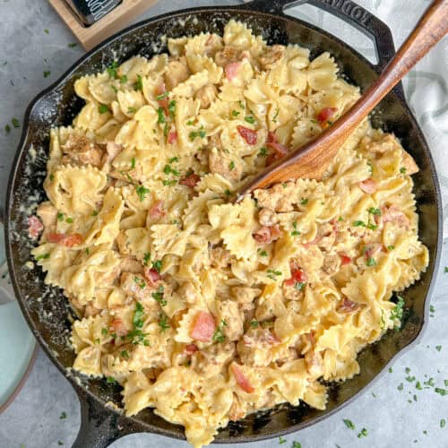 Chicken bacon ranch pasta in a skillet with a wooden spoon.