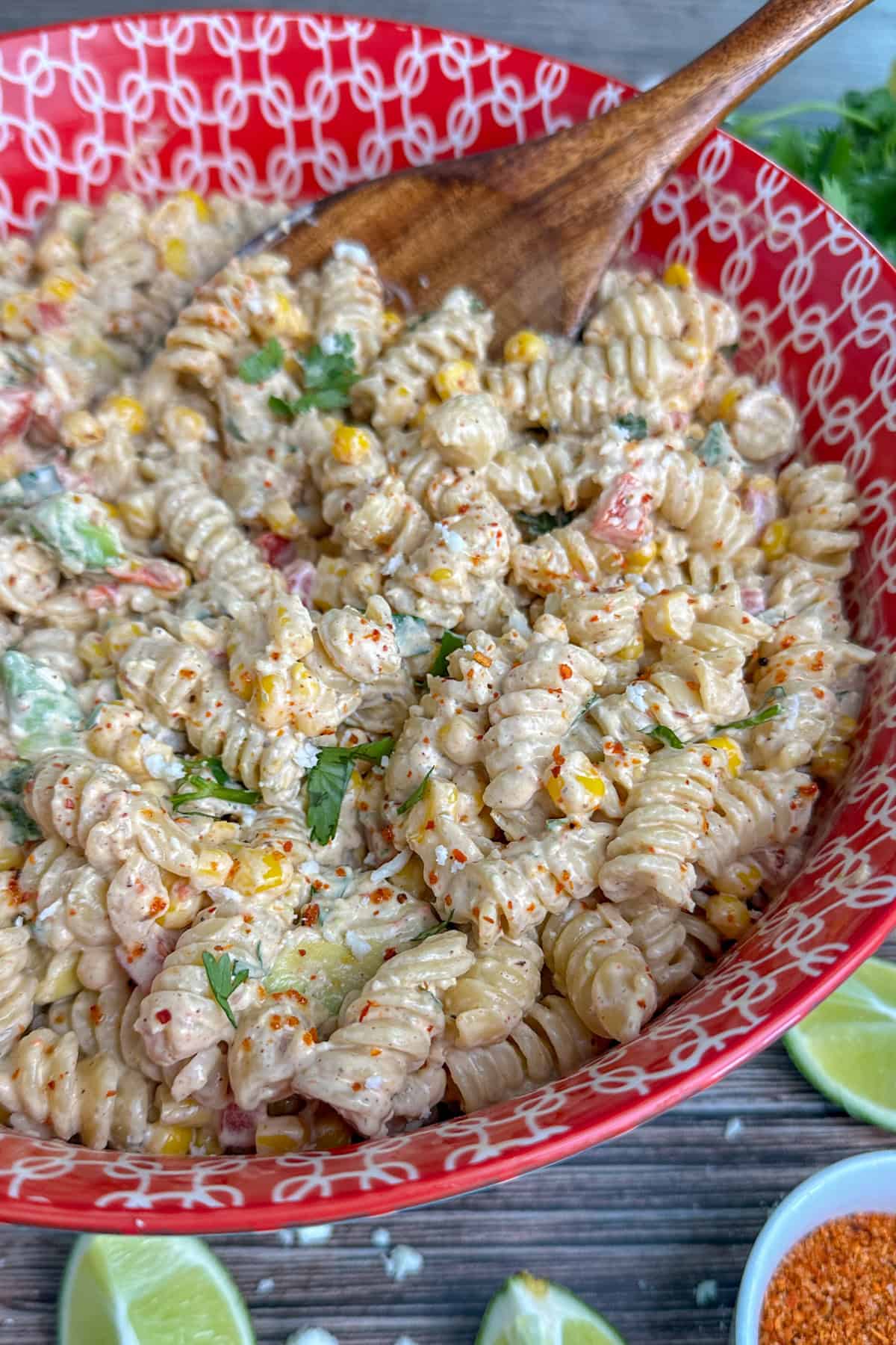 Mexican street corn pasta salad in a red colorful bowl ready to be served.