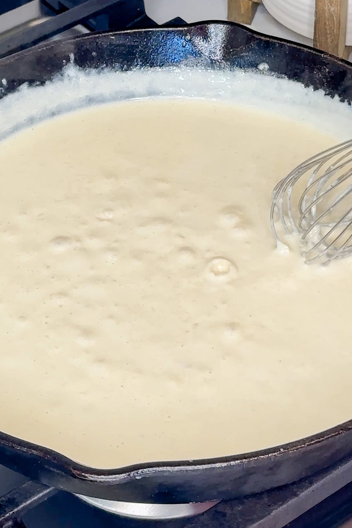 Homemade alfredo sauce in a cast iron skillet.