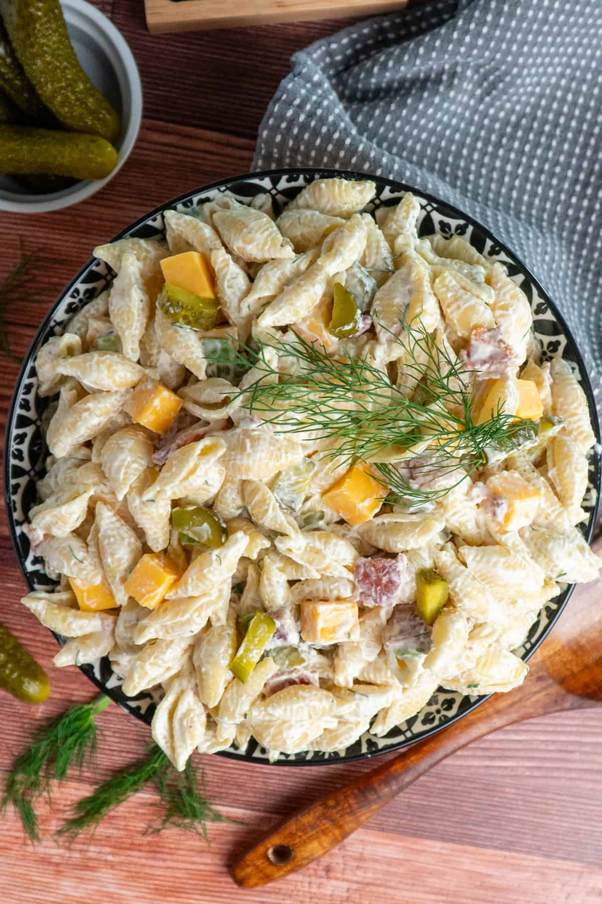 Dill pickle pasta salad in a colorful bowl the has been refrigerated for 2 hours and is ready to be served.