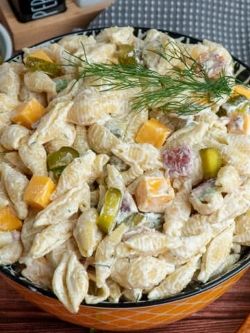Dill pickle pasta salad in a colorful bowl ready to be served.