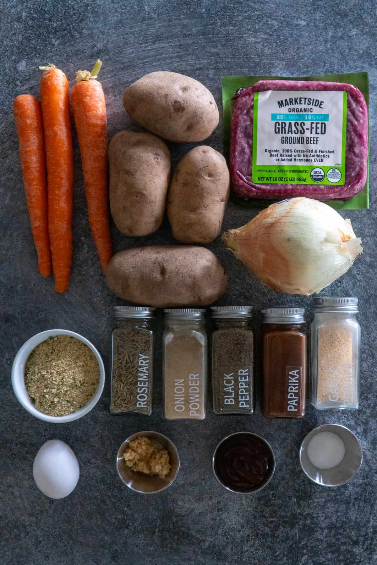 Ingredients to make hobo dinners on a gray countertop.