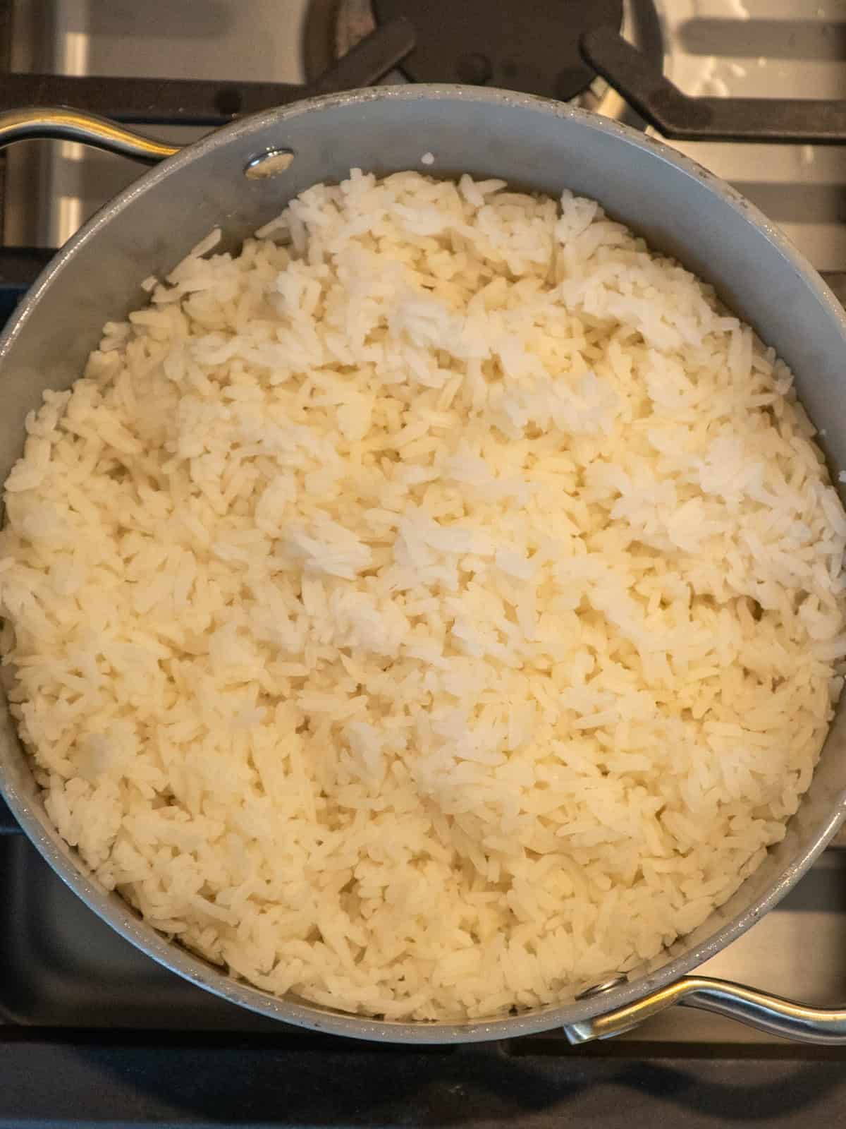Cooked and fluffed jasmine rice in a pot.