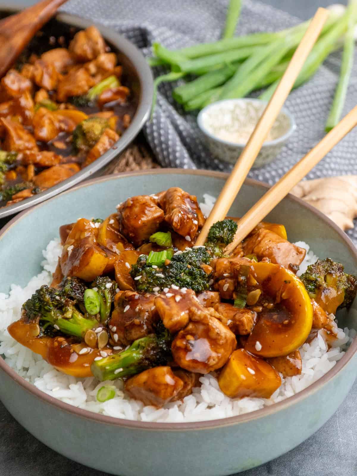 Teriyaki chicken and vegetables added to a bowl of rice.