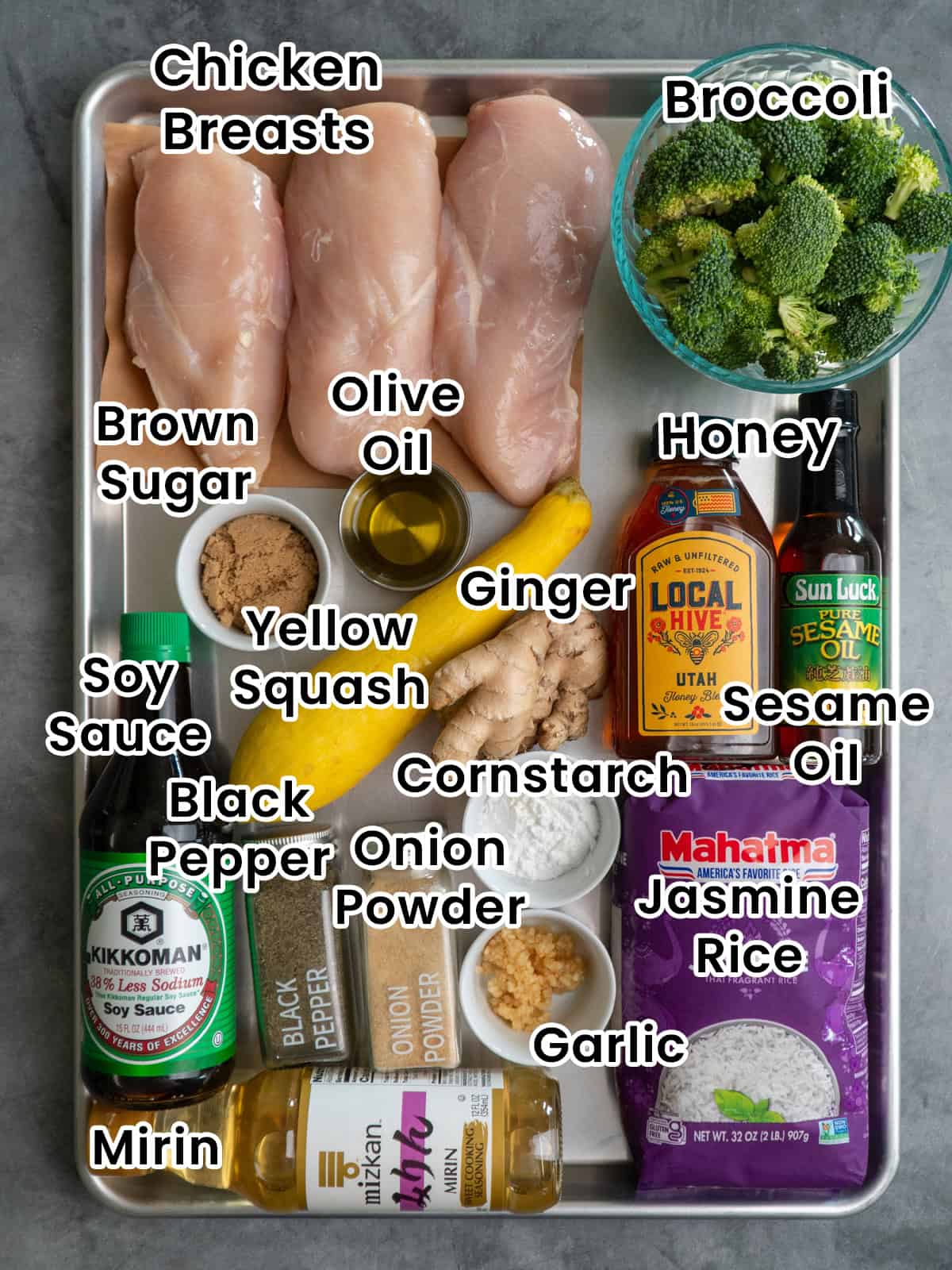 Ingredients to make teriyaki chicken bowls on a baking sheet.